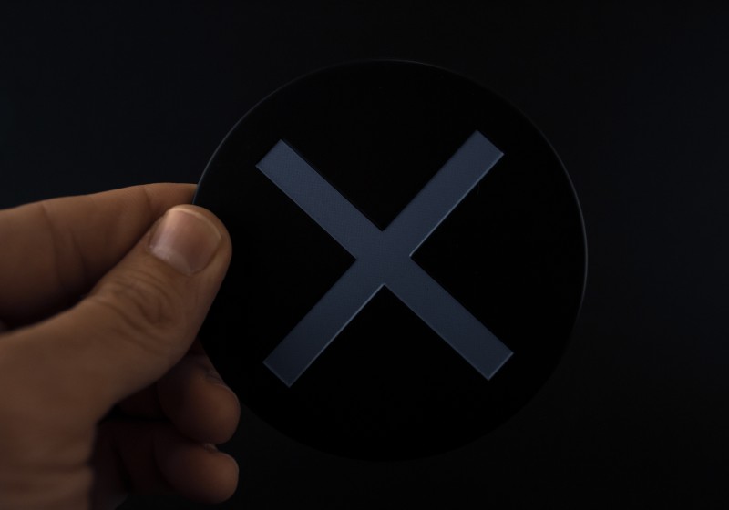 PlayStation metal coasters in package on a black background | Minimal X-Shaped Coasters
