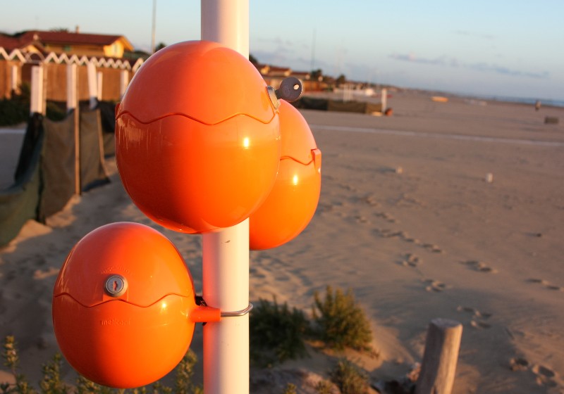 cute orange eggs, oval balls for charging mobile phones right by the sea | Cute Charging Station