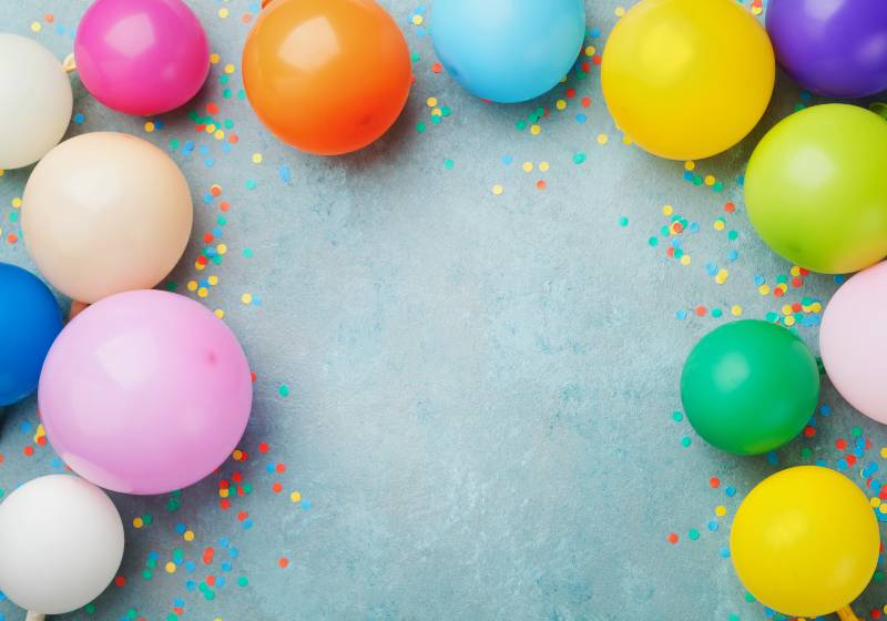 Colorful balloons and confetti on blue table top view | DIY Balloon Bowl You Can Actually Make from Scratch