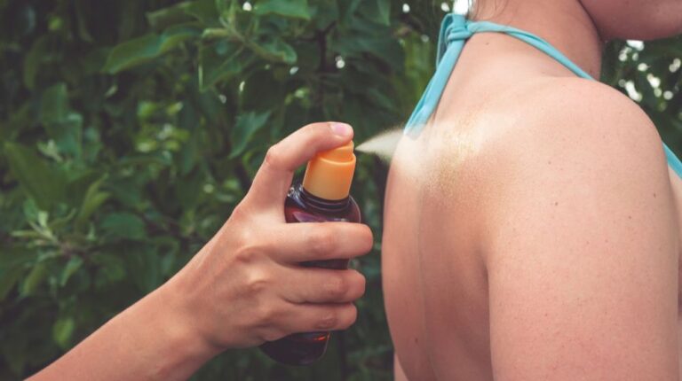 Girl oil spray tanning her legs protection from the sun's uv rays putting sunscreen lotion | DIY Tanning Oil Recipe | make your own tanning oil | Featured