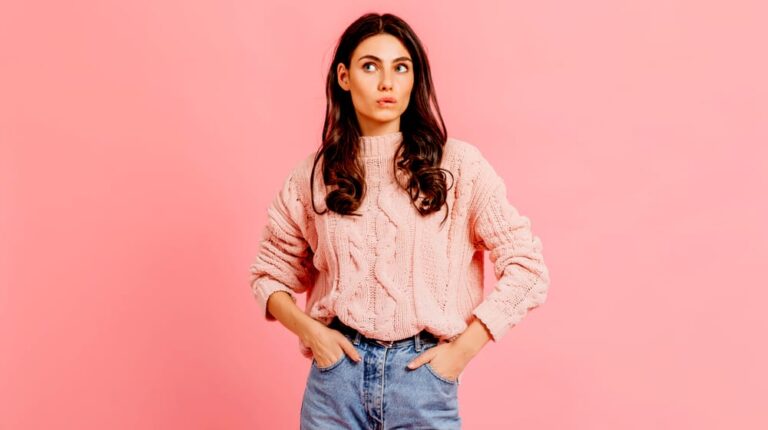 woman wearing a pink knitted sweater | Cozy Cable Knit Sweater Patterns For The Fall Weather | Featured