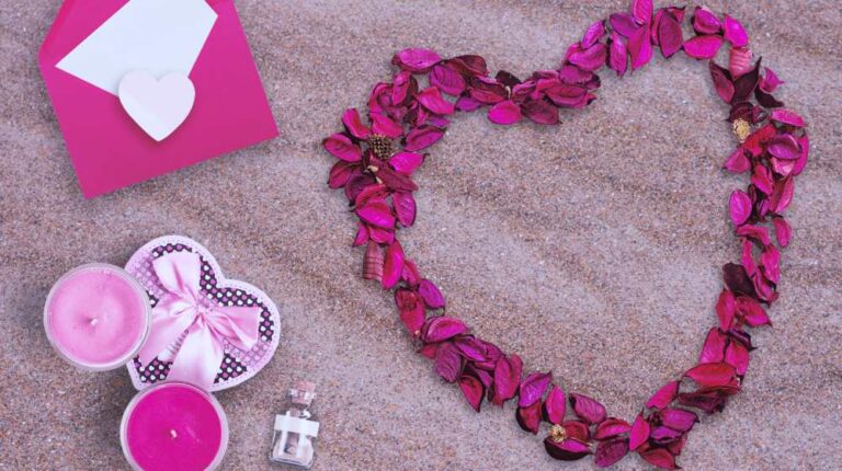 Flower heart beside candle and letter in the sand | DIY Valentine Gifts You Can Make In Under An Hour | diy valentine gifts | Featured