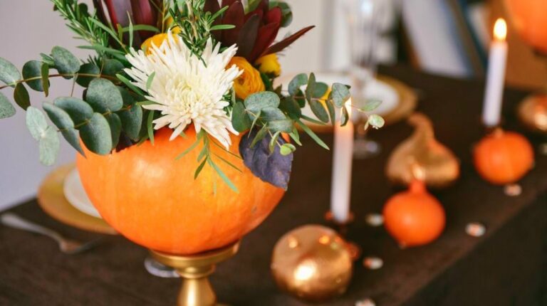 Autumn floral bouquet in a pumpkin vase for Halloween | Ways To Decorate Your Home With Pumpkins This Fall | decorating with pumpkins outside