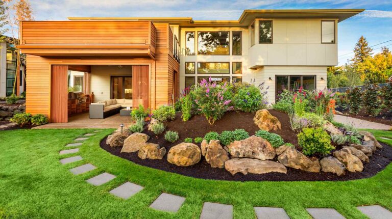 Beautiful luxury home exterior with balcony and green grass on sunny afternoon | DIY Front Yard Makeover Ideas You'll Love | Featured