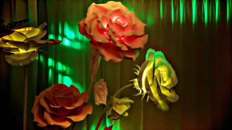 Feature | Flowers of multi-colored paper and cardboard, homemade in a dark interior | Construction Paper Flowers | DIY Flower Craft Ideas