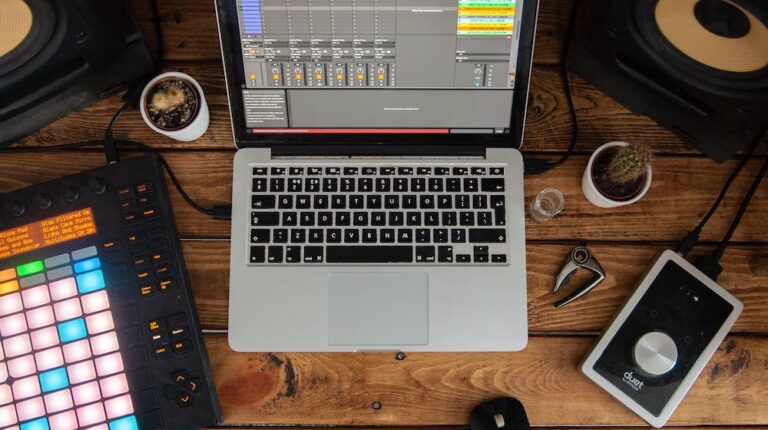 Black and grey laptop computer near devices | DIY Home Recording Studio Design Without Breaking The Bank | Featured