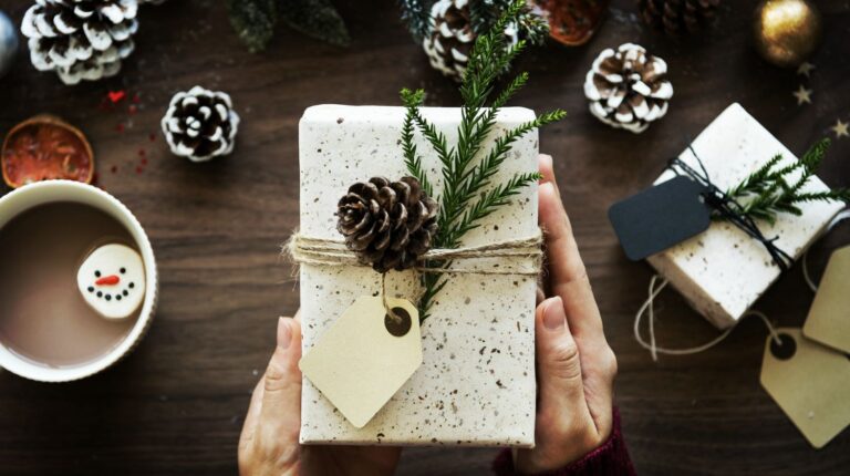 Featured | Hands of woman holding christmas gift box | Awesome DIY Christmas Gift Tags For The Gift-Giving Holiday