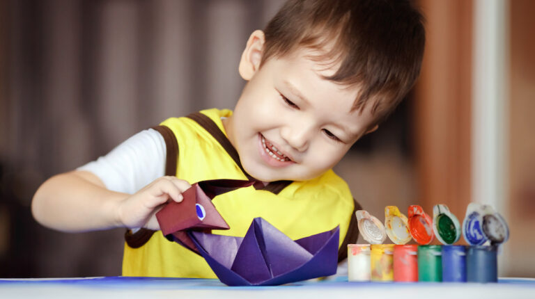 boy playing with origami | Fun And Creative Ocean Crafts To Keep Your Kids Busy | featured