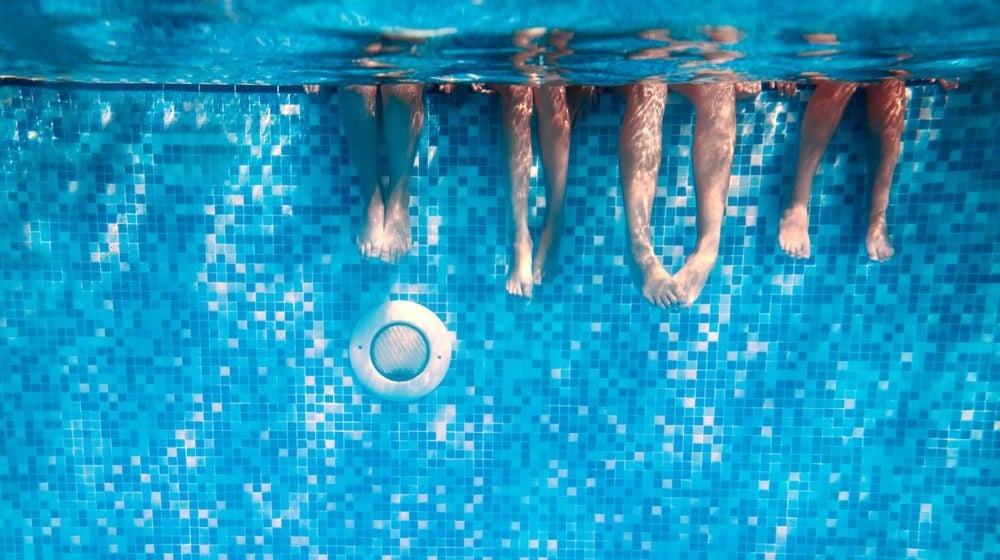 childrens-adults-legs-underwater-swimming-pool | DIY Pool Heater Without Breaking The Bank | Featured