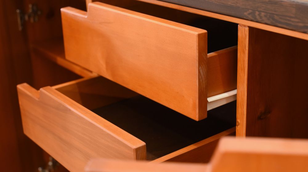 details-wooden-furniture-open-drawers | How To Refinish Cabinets To Make Them Look New Again | Featured