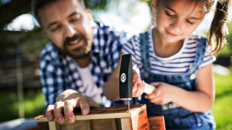 Feature | Father with a small daughter outside, making wooden birdhouse | Save On Crafts | Easy DIY Crafts