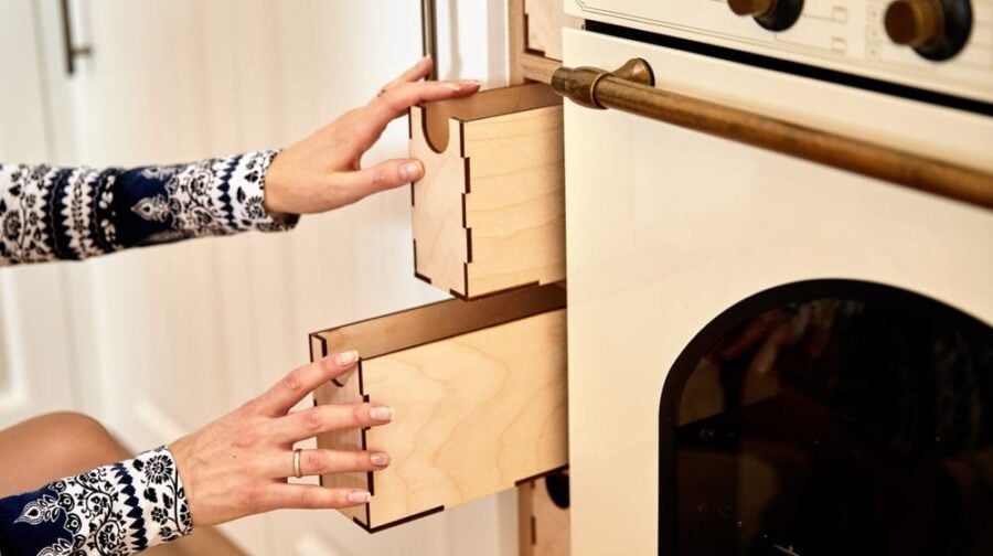female-hands-opening-kitchen-drawers | 25 Smart DIY Hidden Storage Ideas For Every Corner Of Your Home | Featured