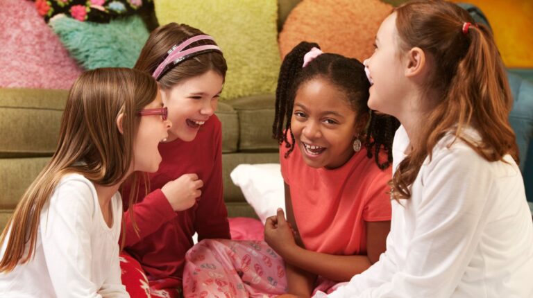 Feature | Happy girls in pajamas at a sleepover | Activities For A Sleepover | Fun Slumber Party Ideas