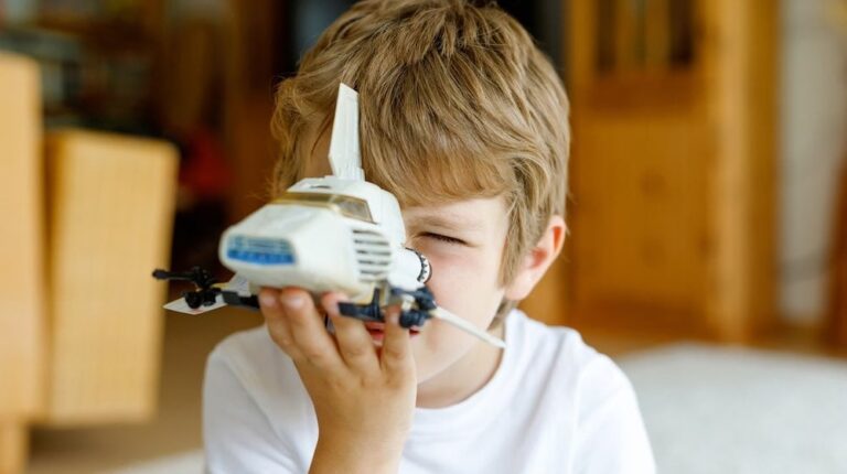Happy little kid boy playing with space shuttle toy | DIY Star Wars Crafts Your Kids Can Do For "May The Fourth Be With You" | star wars crafts for kids | Featured