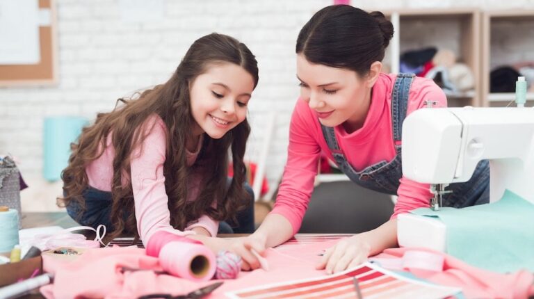 Mom and little daughter together sew clothes | DIY Armchair Caddy To Hold Your Stuff While You're Binge Watching | featured