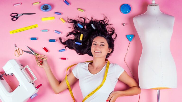 Featured | Young woman designer,sewing machine and maniken in studio pink background | More Sewing Hacks To Make Your Life Easier