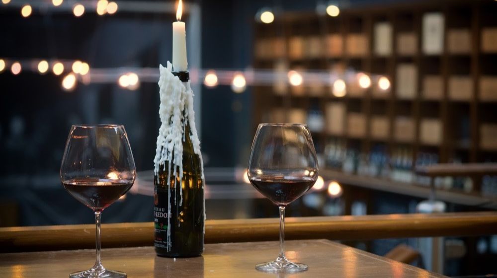 two-glasses-red-wine-on-table | DIY Wine Bottle Candle Holder | Featured