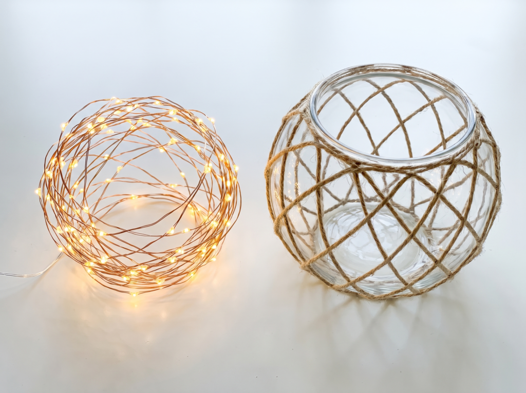 Warm white fairy light strand scrunched into a hollow ball beside a twine wrapped glass bowl