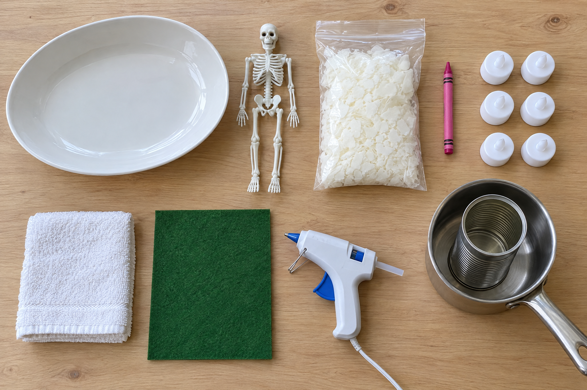 Skeleton spa day candle supplies: ceramic bowl, mini skeleton, soy wax flakes, crayon, LED tea lights, washcloth, felt and glue gun