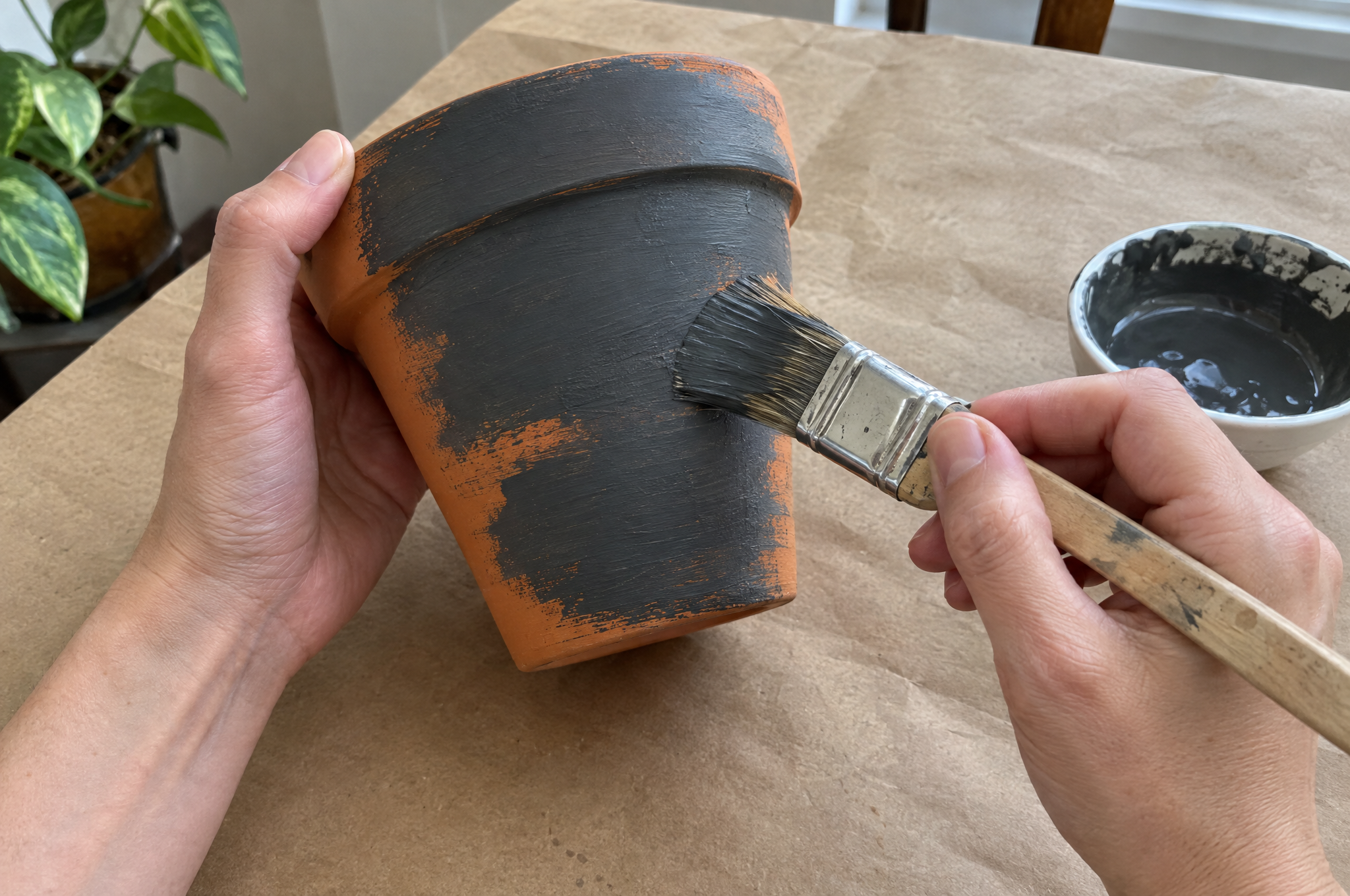 Painting a terracotta pot dark gray for a haunted house planter